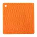Orange silicone mat with honeycomb pattern on a white background