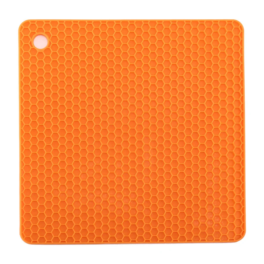 Orange silicone mat with honeycomb pattern on a white background