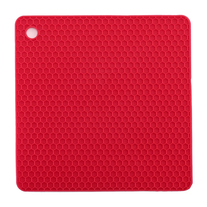 Red silicone mat with honeycomb pattern on a white background