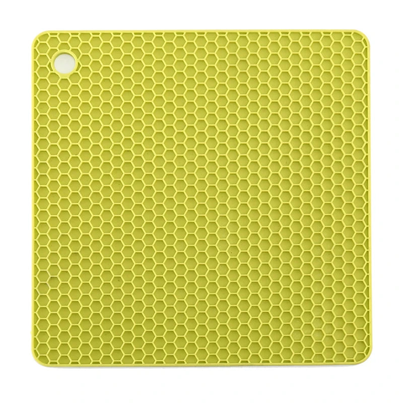 Yellow silicone mat with honeycomb pattern on a white background