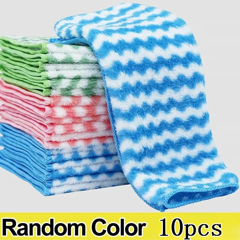 Stack of colorful folded towels with a blue and white patterned towel on top, on a light gray background.