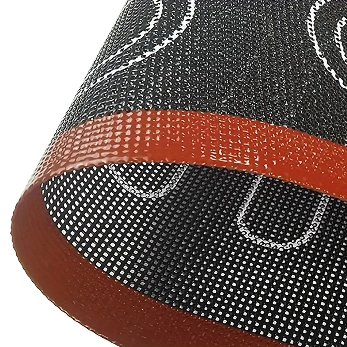 Close-up of a shoe sole with black mesh and brown rubber, featuring a brand logo.