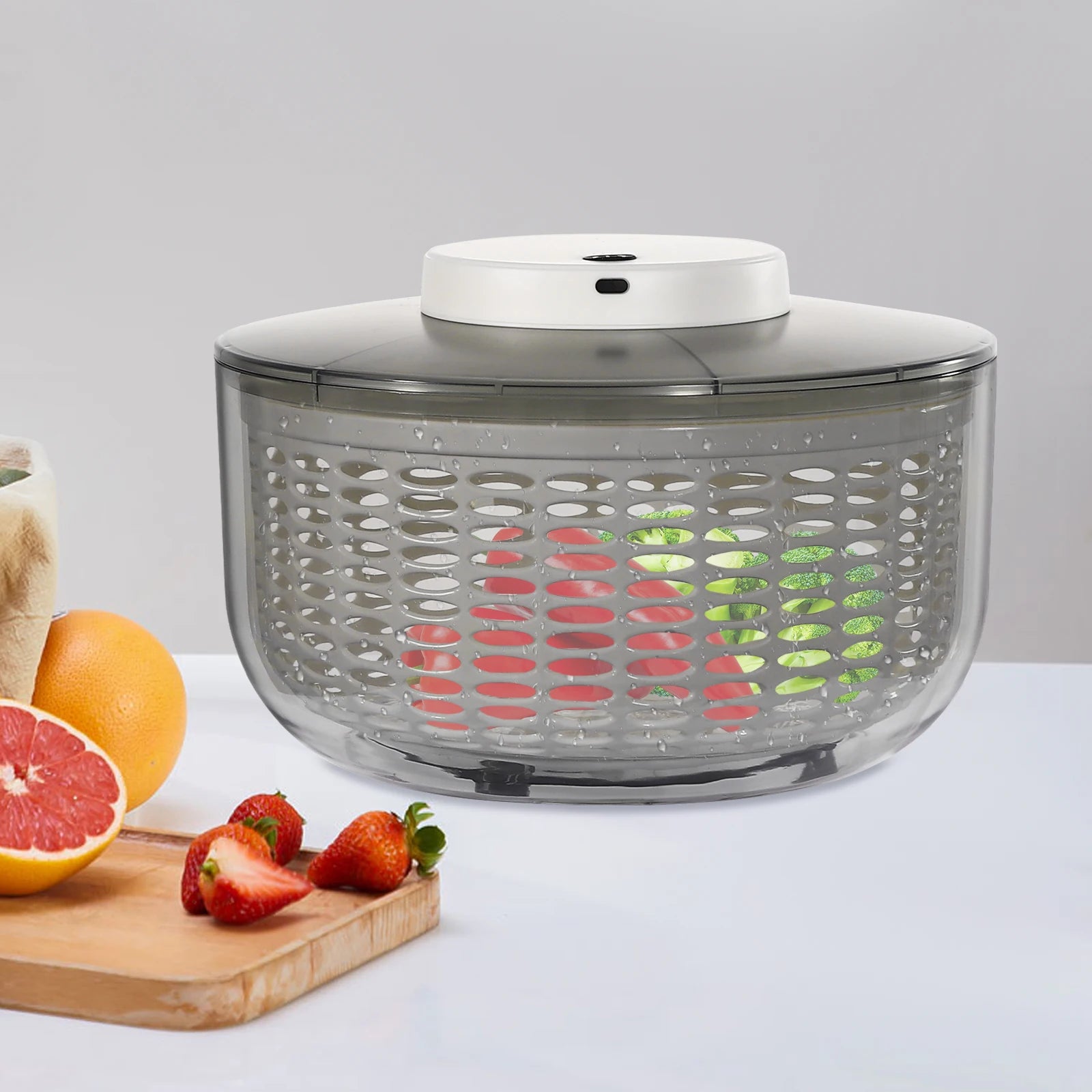 Salad spinner with fruits on a white surface