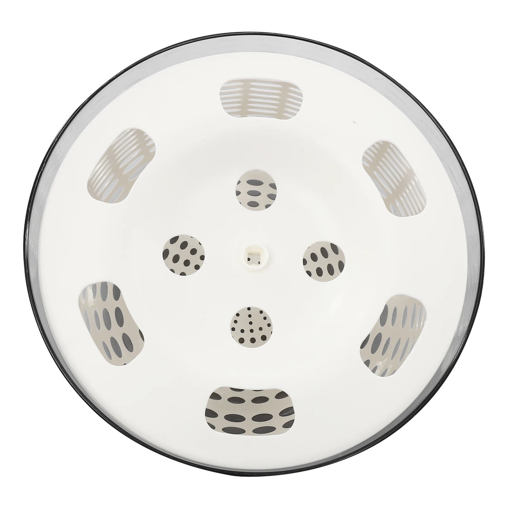 A round white ceramic sink lid with a black rim, decorated with a pattern of gray and black abstract shapes.