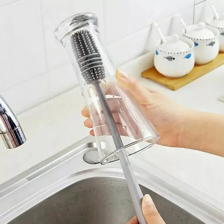 Person using a kitchen sink strainer to clean a glass.