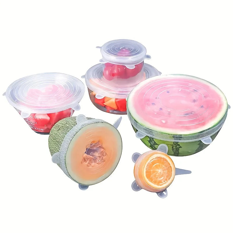 Set of silicone fruit covers on various fruits against a white background