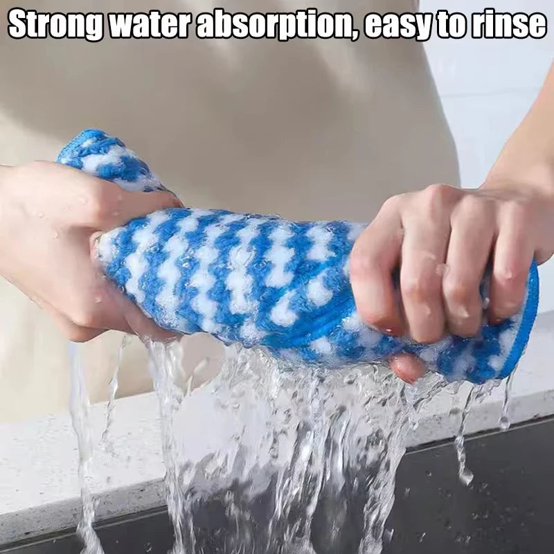 Person squeezing a blue and white scrubber under running water with text 'Strong water absorption, easy to rinse'.