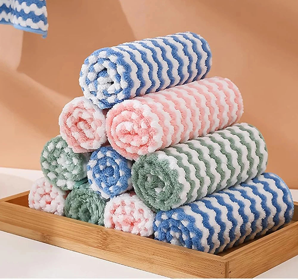 Stack of colorful textured towels on a wooden tray with a beige background