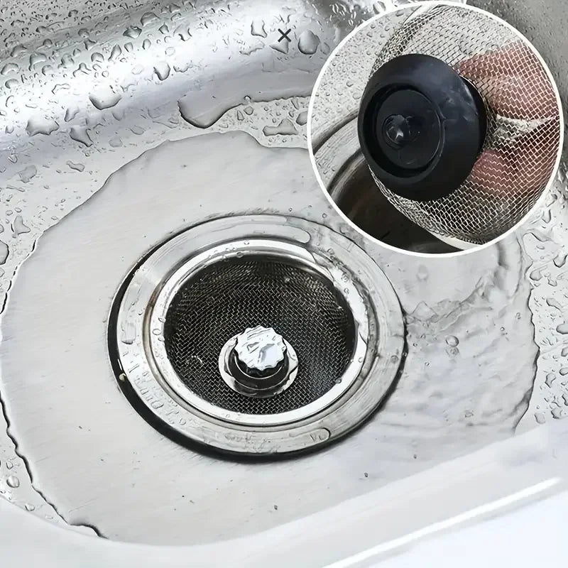 Sewer drain with a metal screen in a sink, showing close-up details.