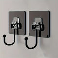Two black wall hooks with metallic brackets on a light gray background