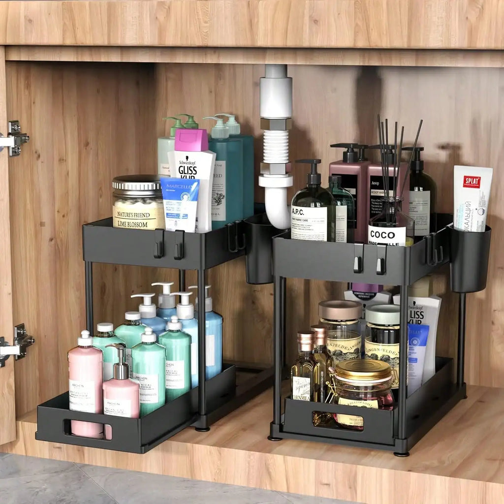 Bathroom cabinet with two black storage organizers holding various toiletries.