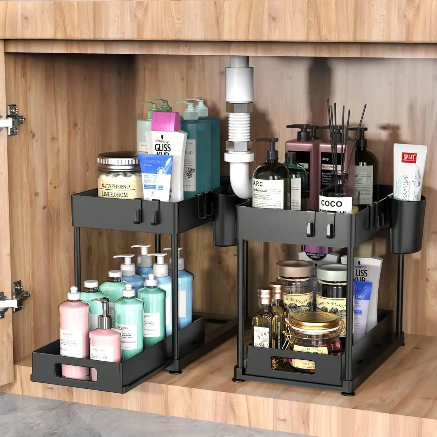 Bathroom cabinet with two black storage organizers holding various toiletries.