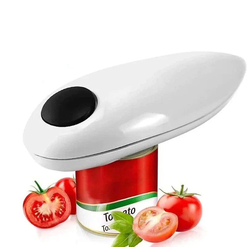 A white electric can opener with a black circular button, shown resting on top of a tomato can with fresh tomatoes and basil leaves around it, on a white background.