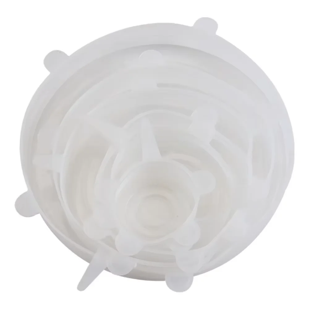 Set of white silicone stretch lids on a white background
