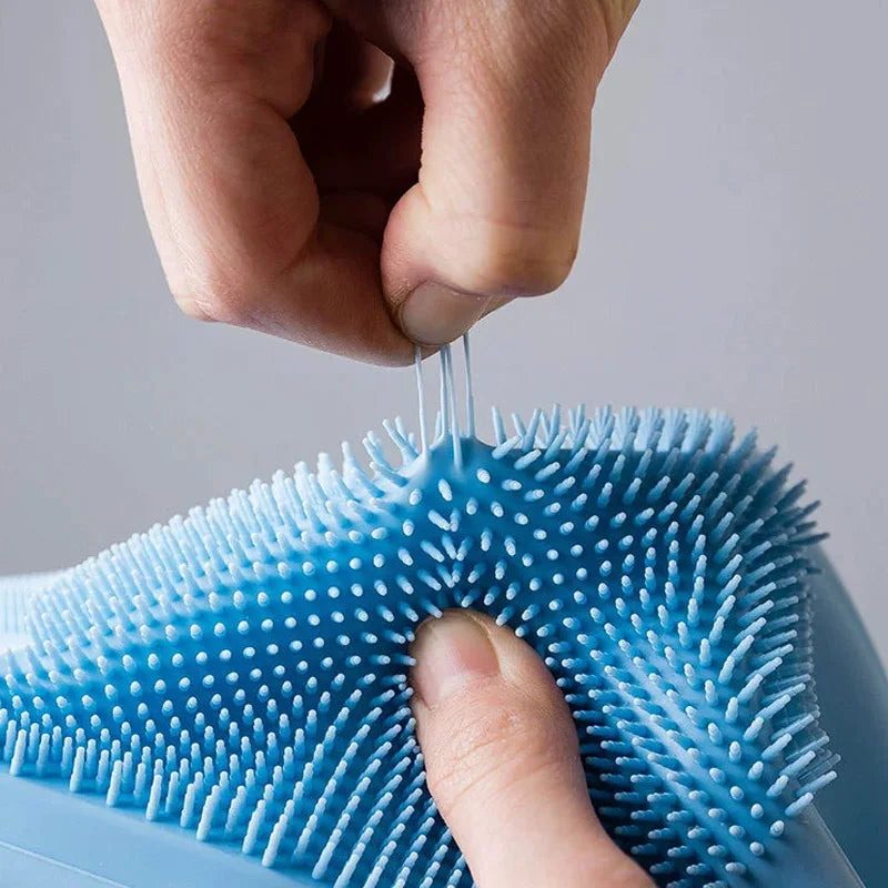 Person using a blue scrubber with white bristles on a gray background