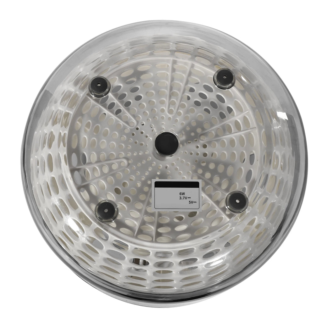 A round clear plastic steamer basket insert with a perforated design, black feet, and a small size label, shown on a white background.