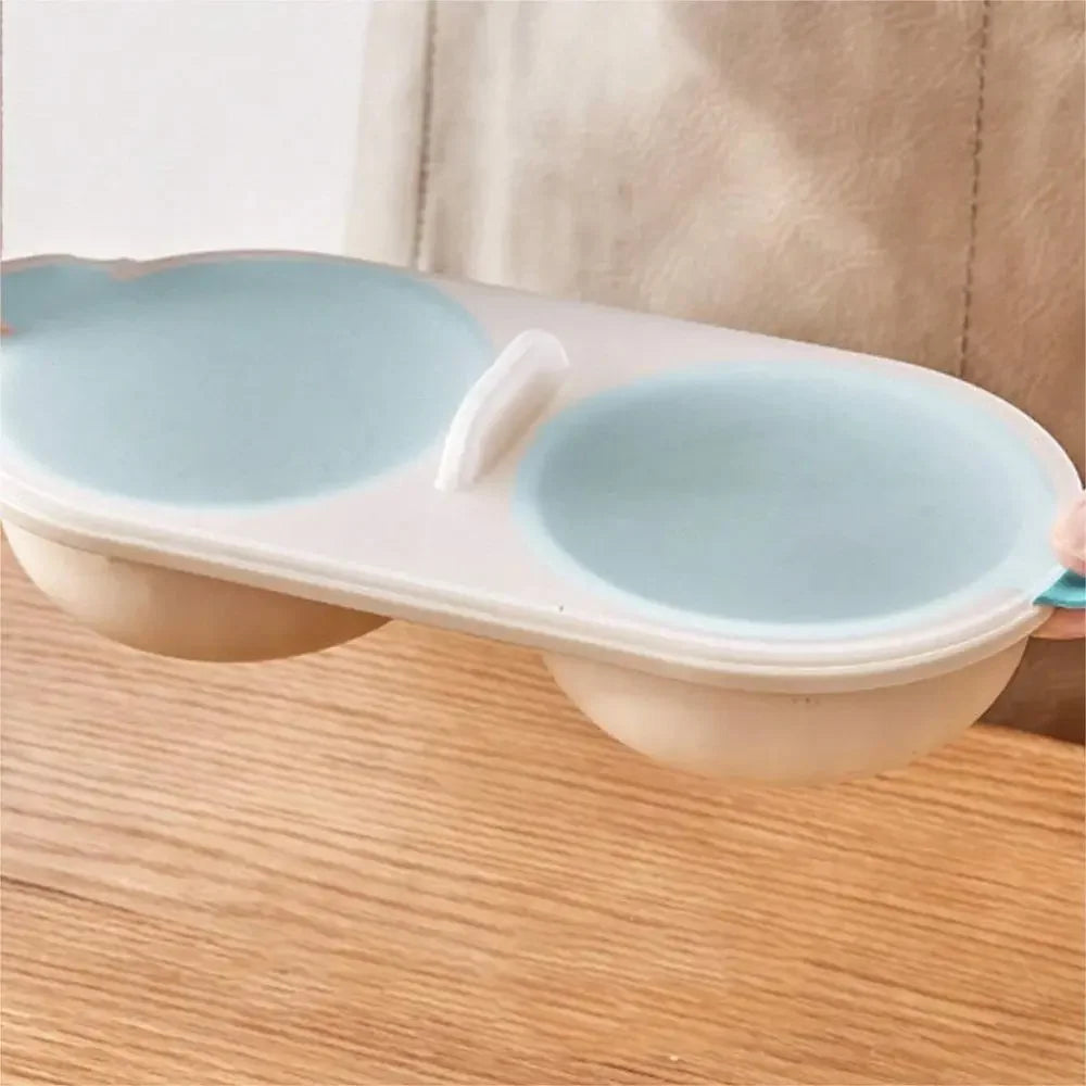 Two blue pet bowls in a white holder on a wooden surface.
