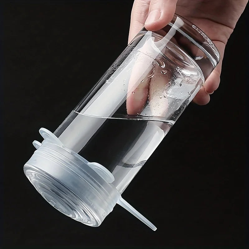 Clear water bottle with straw and lid held by a hand against a black background