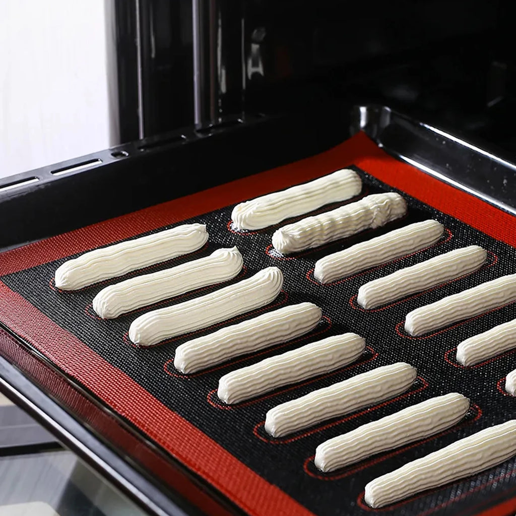 Baked goods on a baking tray with a silicone mat inside an oven.