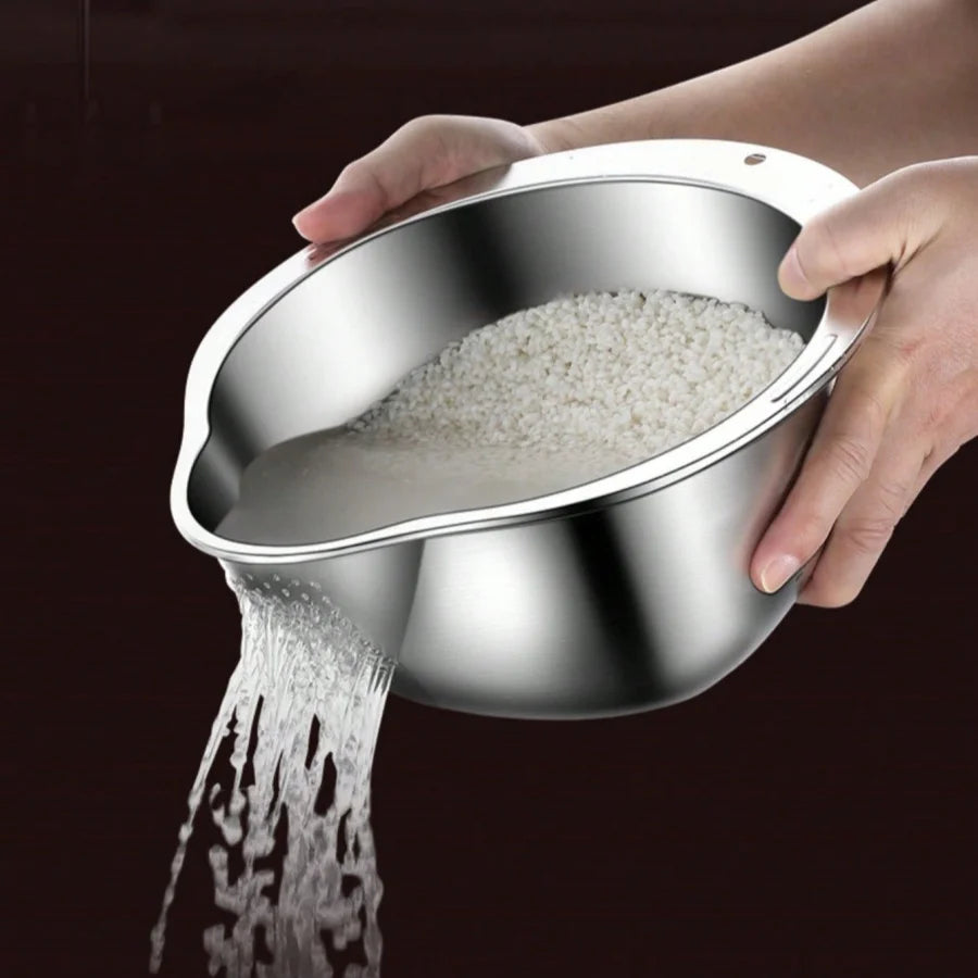 Stainless steel bowl being held with rice being poured out on a dark background