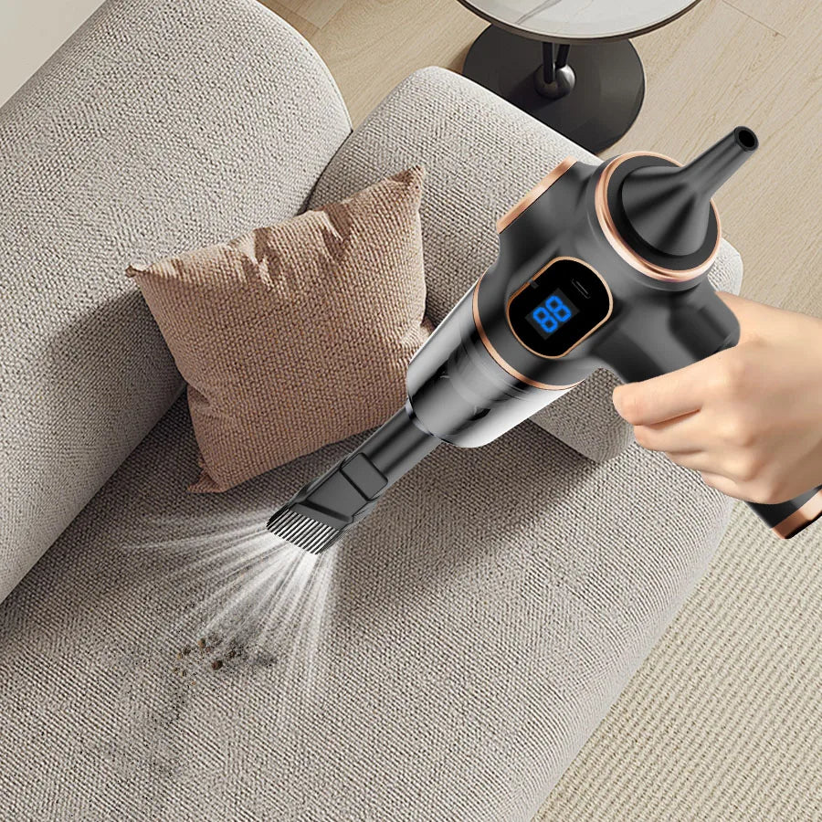 Handheld vacuum cleaning a sofa with visible dirt collection.