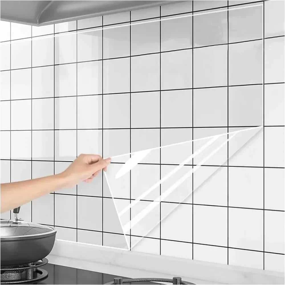 Person holding a transparent sheet against a tiled kitchen wall