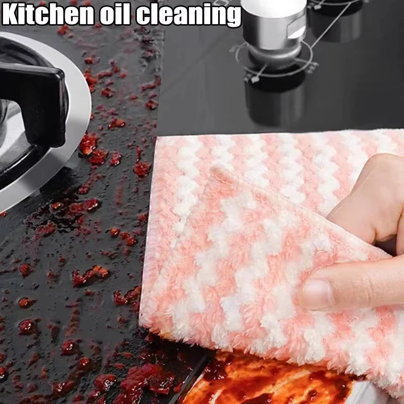 Cleaning a stained kitchen surface with a pink and white cloth.