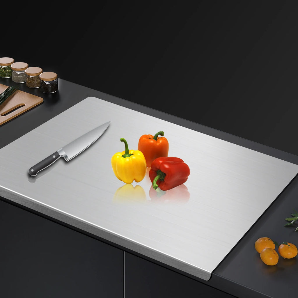 Chopping board with knife and colorful peppers on a dark kitchen counter